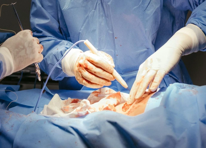 a surgeon performing surgery on a patient in an operating room